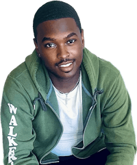 a young man in a green hoodie sitting on a black background